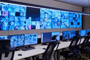 Empty interior of big modern security system control room - Powered by Adobe