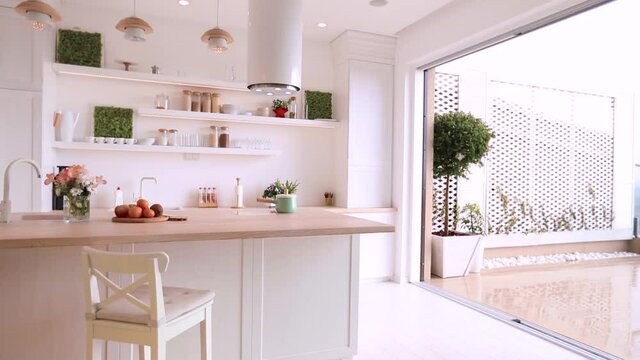 open space kitchen with sliding doors and patio at rainy, drizzling day