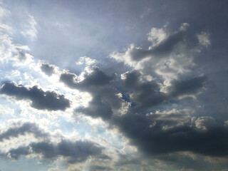 Dark clouds and sunlight behind the clouds.  Rainy season.  Climate, air, atmosphere.