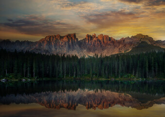 Fototapeta na wymiar Reflections on Mountain lake,Lake of Carezza Doromites Italy