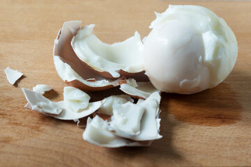 boiled chicken eggs are poorly cleaned from the shell. the shell is peeled off along with the...