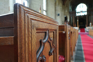 Close up of empty pews in a parish church in the UK