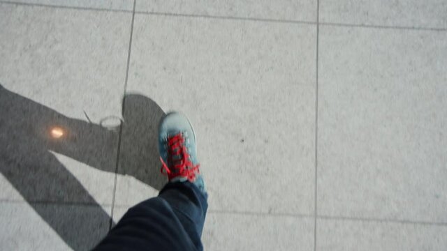 Top view boots walk on tile indoors floor. Male blue shoes step on shiny clean airport terminal floor towards new adventures. Walk step by step in big city life, office routine concept