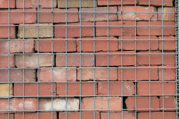 Red stone and metal mesh