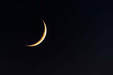 Fototapeta na wymiar Waning (the moon) in the dark sky