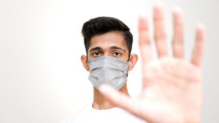 Face of a young man with a mask, hand gesture of young man, man stopping hand gesture, doctore hand gesture