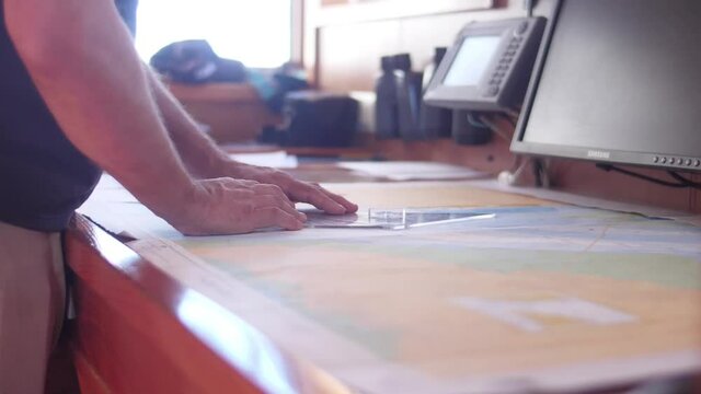 sailor reading nautical chart map ship boat slow motion