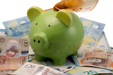 Piggy bank with Euro and British sterling banknotes