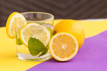 glass of lemonade.  Glass with water and lemon and fresh mint 