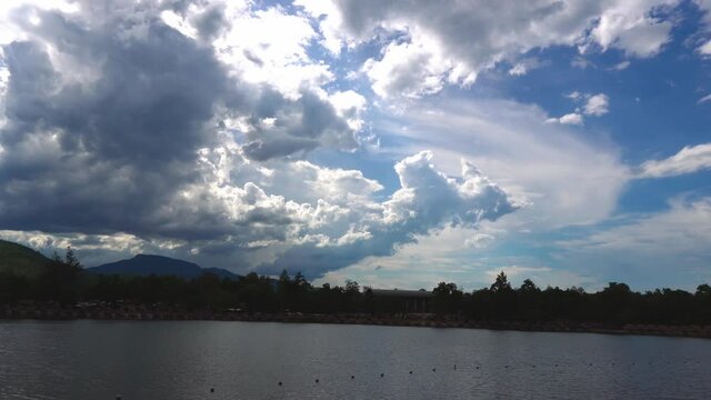Lake Daytime - Overtime, blue sky video Clouds and shadows of a river near a lake in the Huat Tia Tao Mountains, Chiang Mai Province, Thailand
