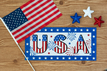 Fototapeta na wymiar Independence Day July 4th, President's Day, Memorial Day Labor Day, Veteran's Day, Great America. USA sign in the colors of the flag of the United States on a wooden background with stars and the flag