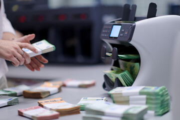 Bank employees sorting and counting paper banknotes