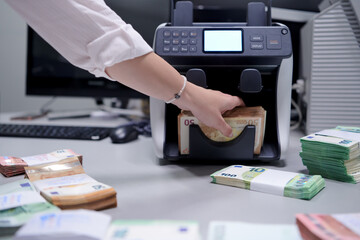 Bank employees sorting and counting paper banknotes