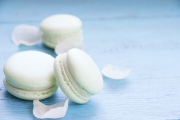 Macaroons on wooden board, blue background