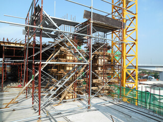 Fototapeta na wymiar MALACCA, MALAYSIA -SEPTEMBER 19, 2016: Column timber formwork and reinforcement bar at the construction site in Malacca, Malaysia. The structure supported by temporary wood support