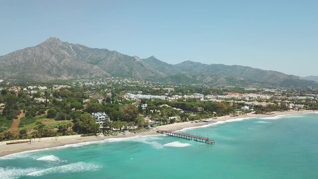 Unique cinematic perspective of Marbella residence area, luxury tourist destination, most expensive area of Marbella with resorts and bars restaurants. La Concha mountain. Golden mile beach. Forward