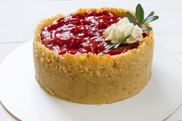 Cheesecake  with strawberry sauce .Homemade fresh  dessert. White wooden board