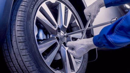 Fototapeta premium Car repairs. Removing the wheel. Replacing wheels.
