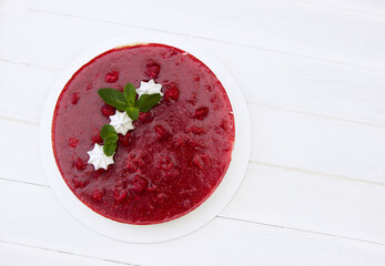 Delicious  strawberry cheesecake decorated mint leaves and  meringue , white background