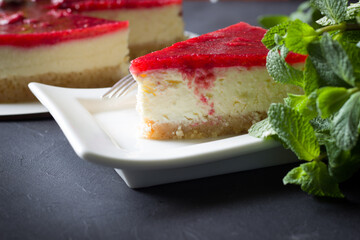 Delicious  strawberry cheesecake decorated mint leaves and  meringue , black background