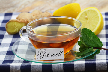 Get well card with cup of hot tea, lemon, mint and fresh ginger
