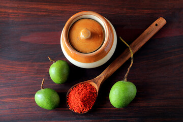 Mango Pickle Masala on a wooden background.