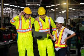 Engineers and skilled technicians are holding laptops and working in industrial plants.