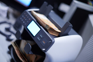 banknotes in front of electronic money counting machine
