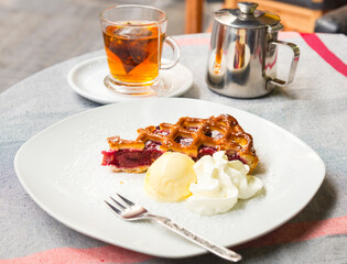 Slice of fruit tart and cup of tea