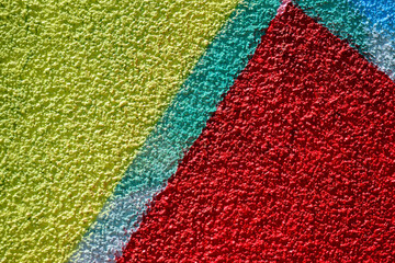 Obraz premium Minimalist textured background with sprayed painted wall like graffiti art, made with with vivid red, yellow and green colors .