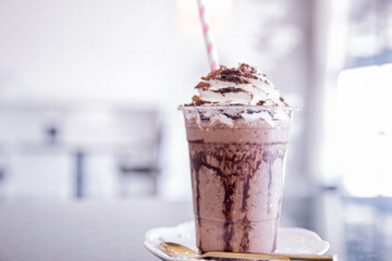 Summer refreshment drinks. Chilled iced chocolate cocoa. Chocolate powder and ice with tubes for drinking in the cafe.