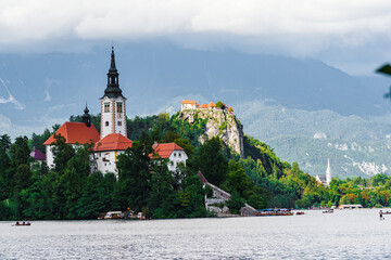 Beautiful cathedral in the middle of the lake surrounded by colourful trees