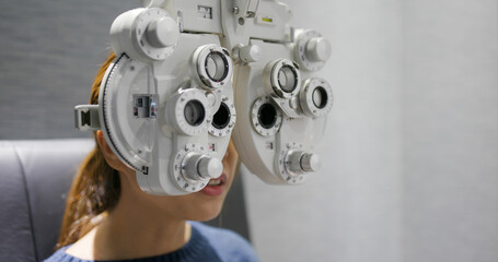 Woman check her eye at clinic