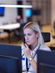 Female security guard operator talking on the phone