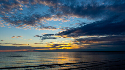 Beautiful dramatic clouds during sunset on the beach.