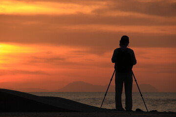 silhouette of a photographer at sunrise