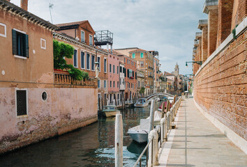 Fototapeta na wymiar Venice, Italy - May 30, 2020: Canal and deserted calle at the time of Covid 19 - Coronavirus