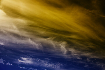 Dramatic cirrus clouds and vapour trails with color.