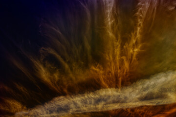 Dramatic cirrus clouds and vapour trails with color.