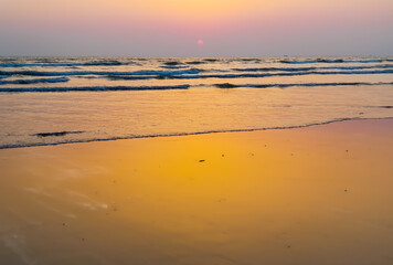 Fototapeta na wymiar Ocean waves hitting the beach of Cox's Bazar in Bangladesh in the evening. The longest beach