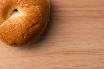 Morning breakfast bagel bread on a wooden background.