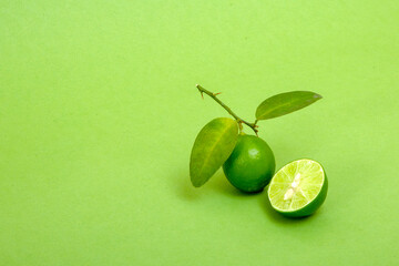 Lemon isolated on green background and cut slice of lemon