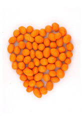 Organic salted peanuts  in heart symbol isolated on white background