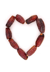 Tasty organic dry dates in form of heart. Isolated on a white background.