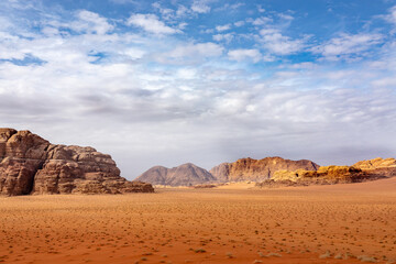 Fototapeta na wymiar Red sand and rocks in the Wadi Rum desert in Jordan.