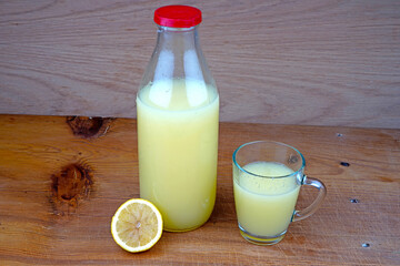 Lemon and lime juice on wooden background