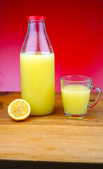 Fototapeta na wymiar Organic Lemon and lime juice on wooden background