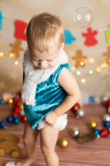 a boy in a Christmas costume standing up shows a leg