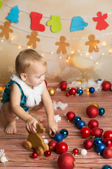 a boy in a Christmas costume plays with a wooden toy