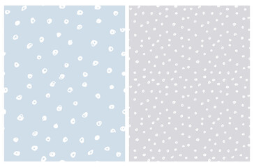 Cute Hand Drawn Abstract Irregular Polka Dots Vector Pattern Set. White Brush Dots on a Pastel Blue and Light Gray Background. Bright Infantile Style Vector Print. Simple Dotted Layout.